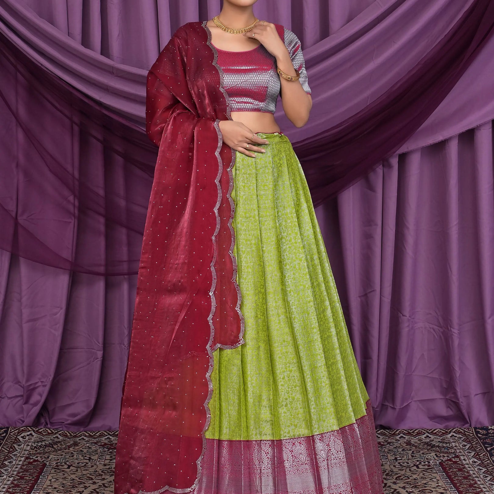 Woman wearing a green and red traditional lehenga choli