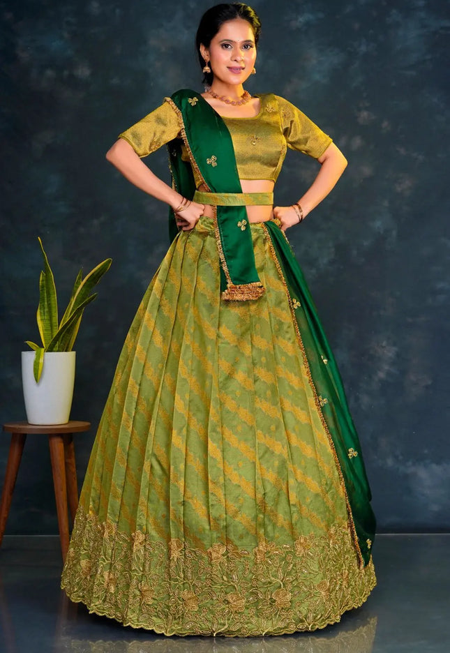 Woman wearing a green traditional outfit with a matching lehenga choli