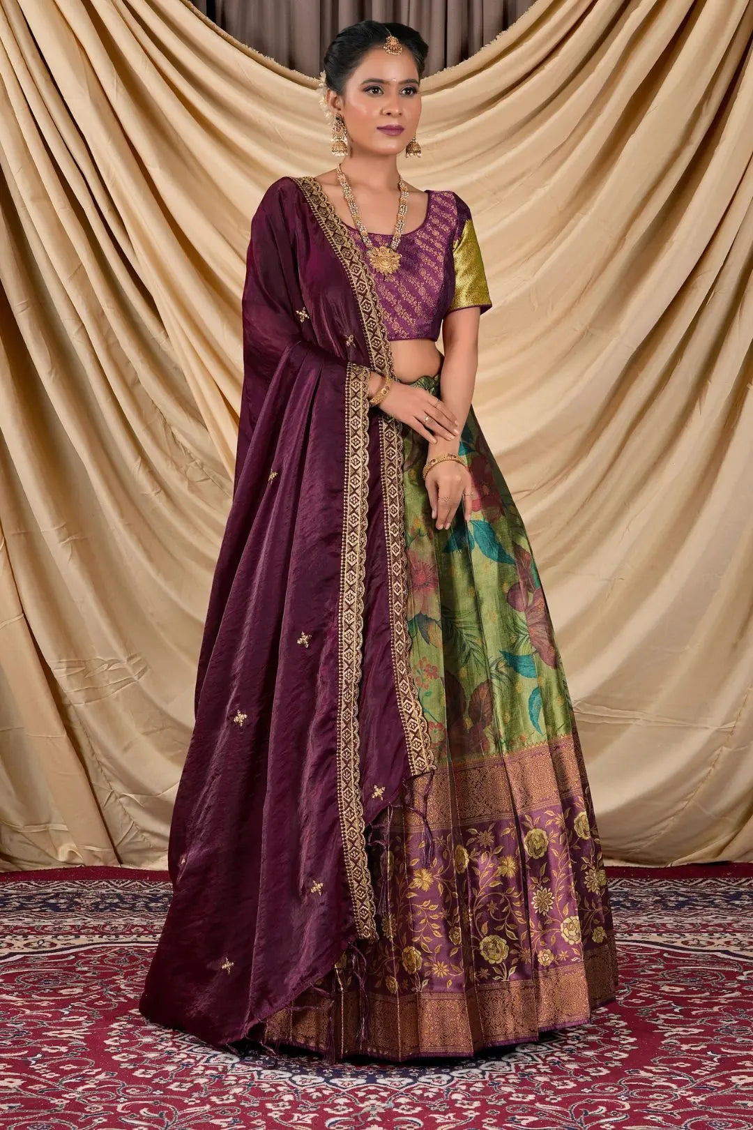 Woman wearing a traditional outfit with a purple dupatta and colorful skirt