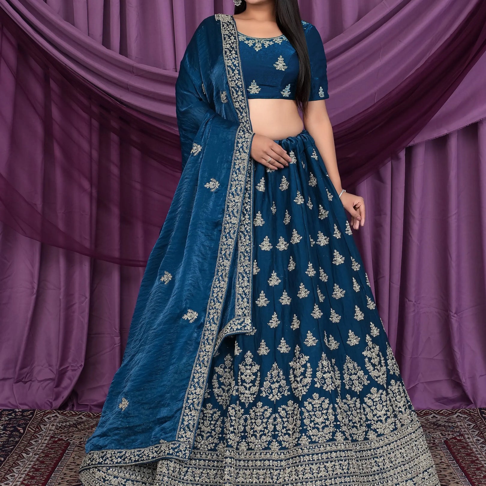 Woman wearing a blue embroidered traditional outfit