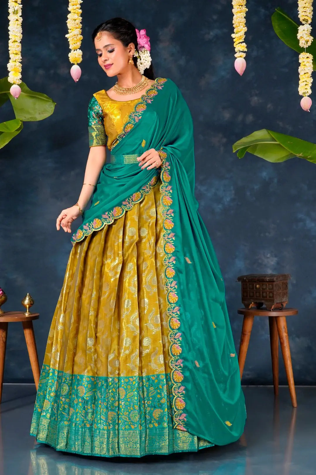 Woman in a green and yellow traditional lehenga choli with dupatta