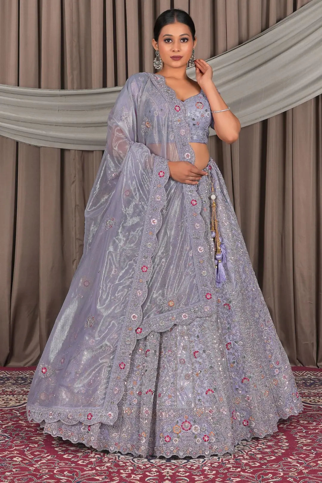 Woman in a traditional lavender embroidered lehenga with a matching dupatta