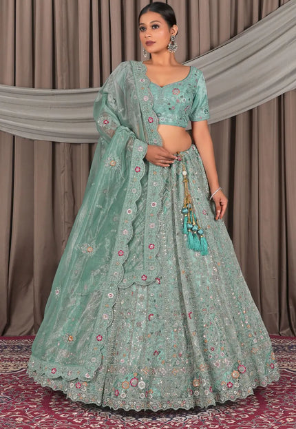 Woman wearing a traditional green outfit with floral patterns