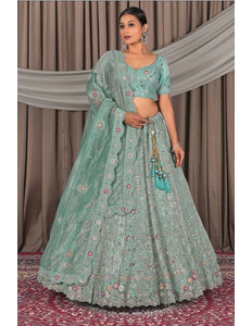 Woman wearing a traditional green outfit with floral patterns