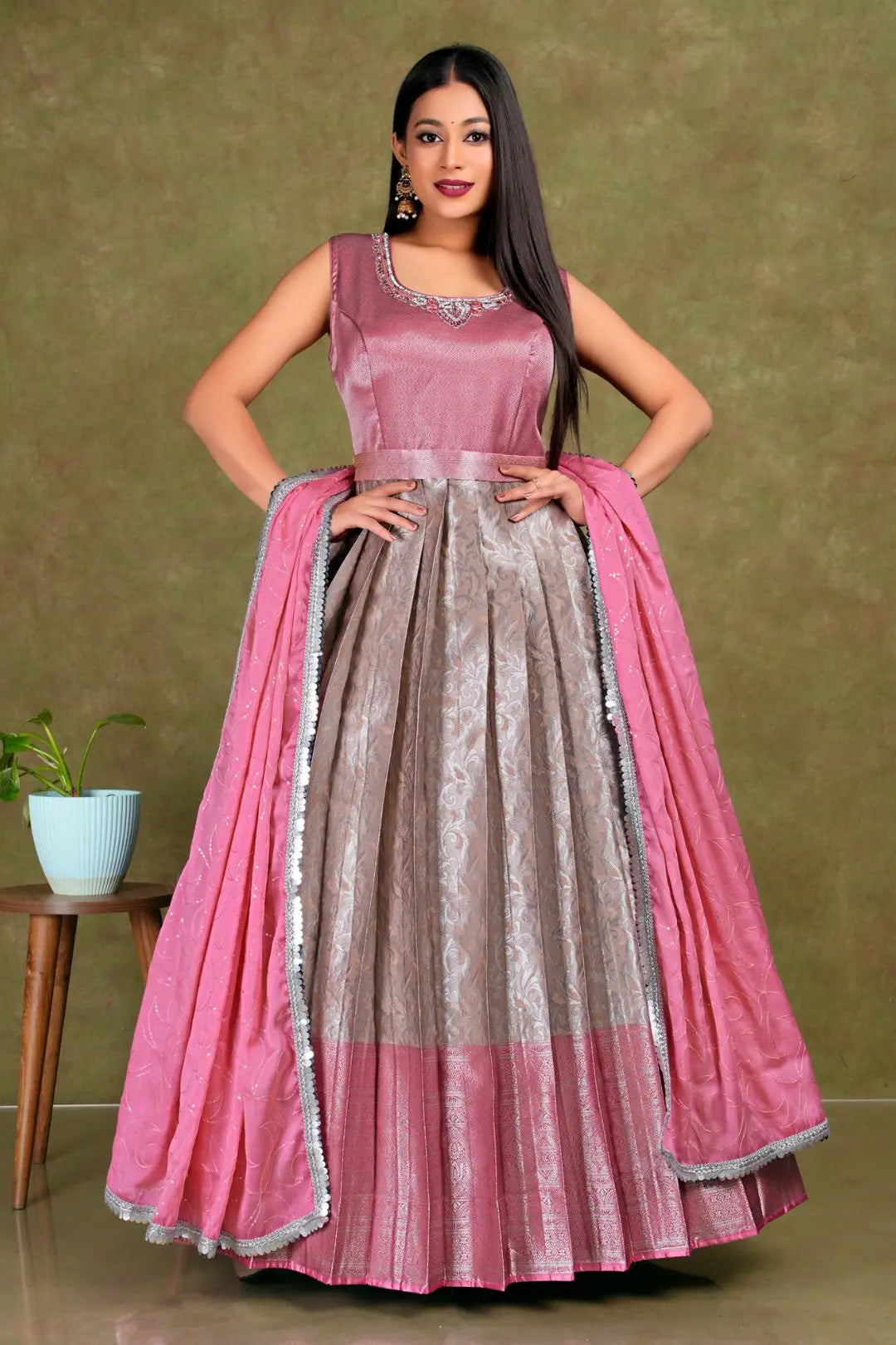 Woman wearing a pink and gray traditional gown with dupatta