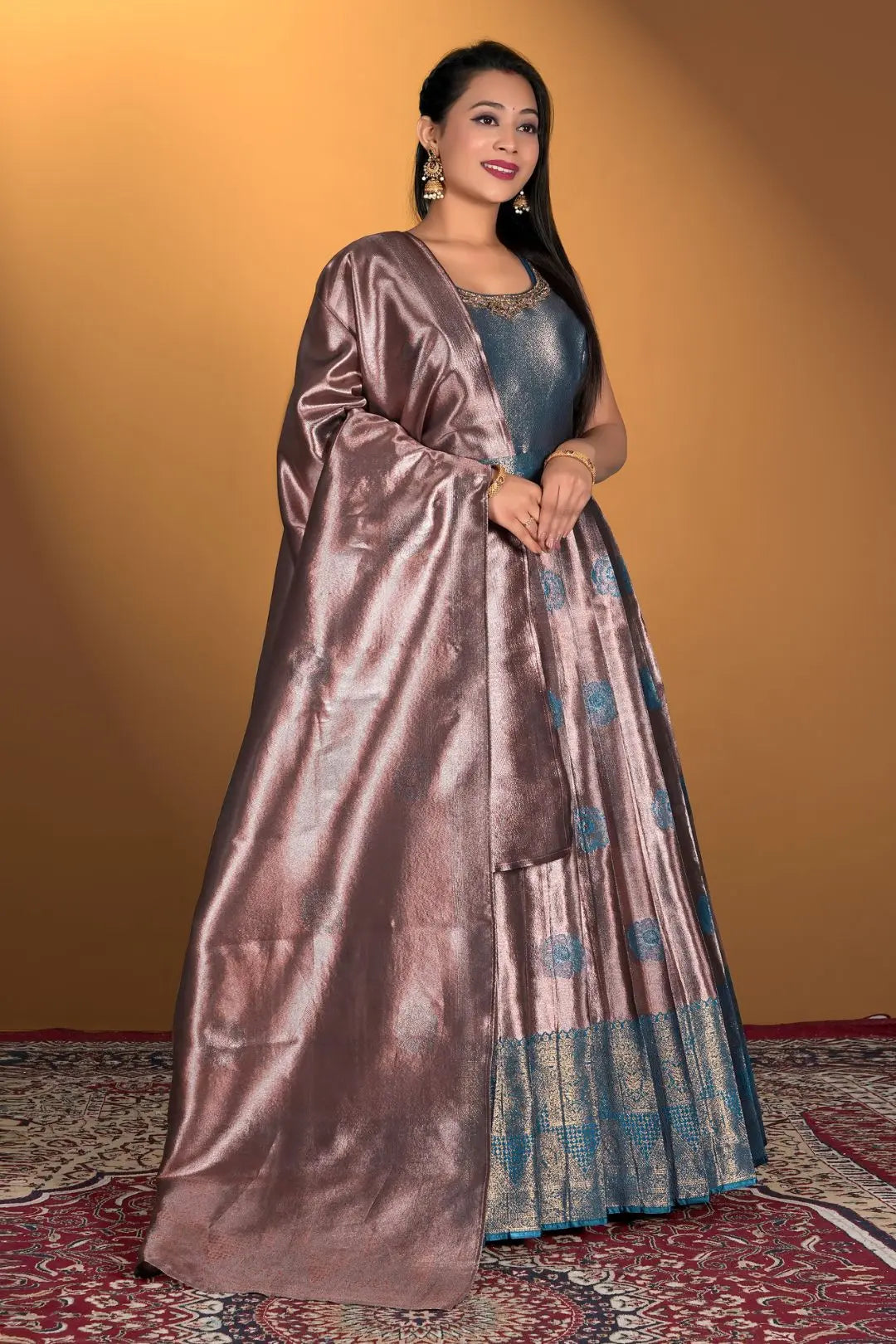 Woman wearing a long, flowing dress with a metallic sheen