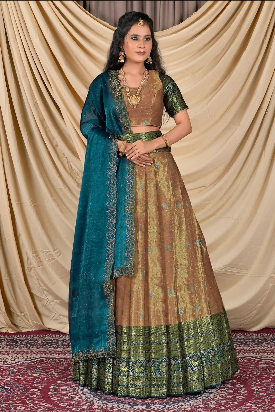 Woman wearing a traditional outfit with a blue dupatta