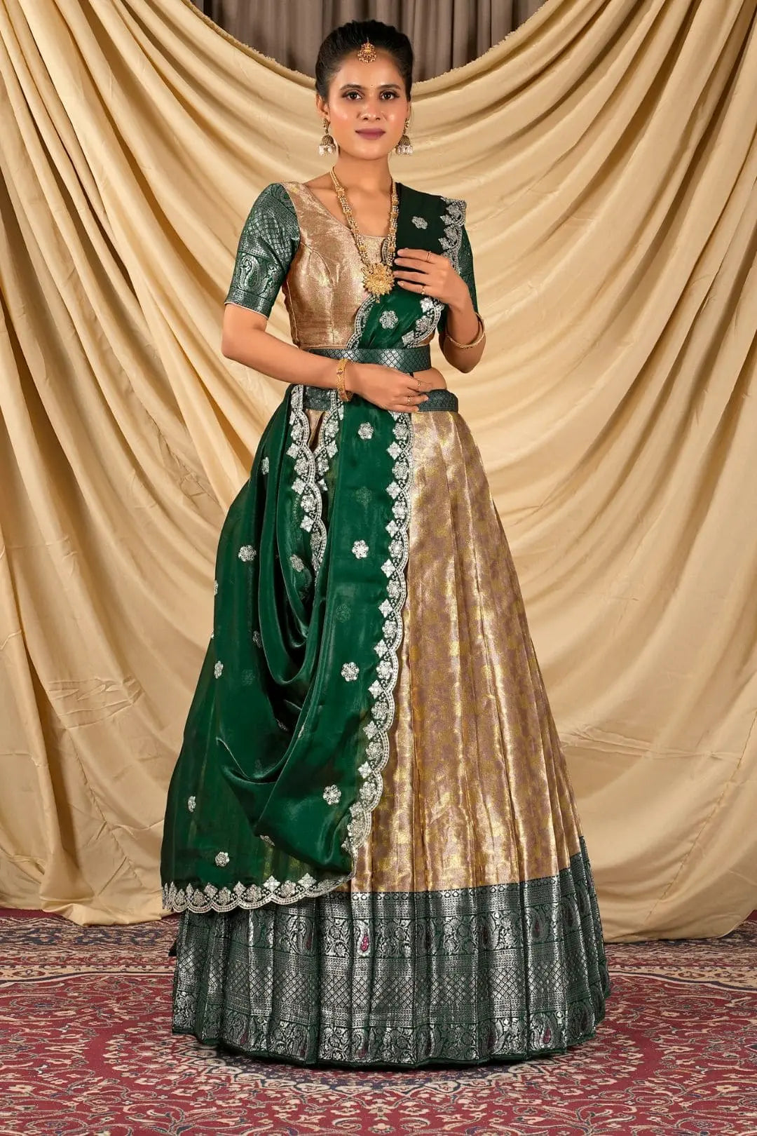 Woman wearing a green and peach lehenga choli with dupatta
