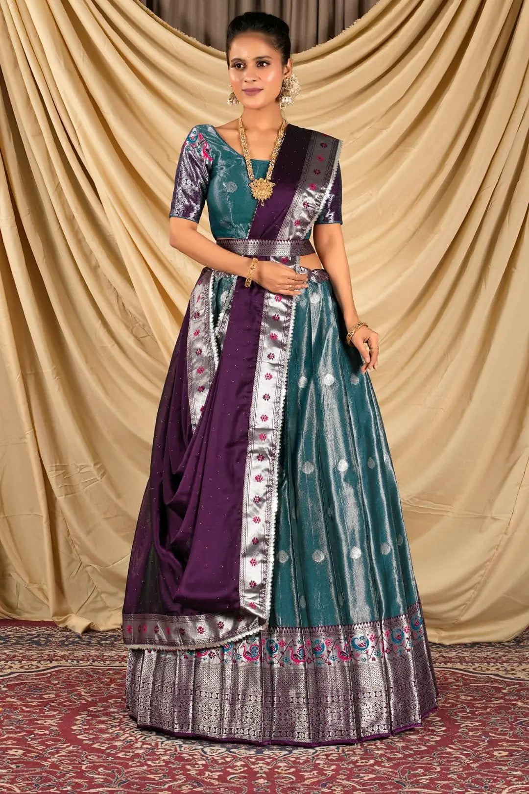 Woman wearing a traditional outfit with a purple and peacock lehenga choli with dupatta