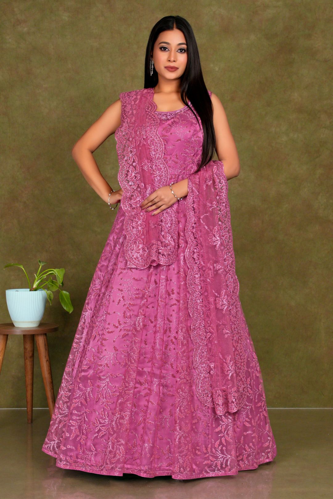 Woman wearing a pink embroidered dress  Pink Colour Party Wear Net Gown For Women