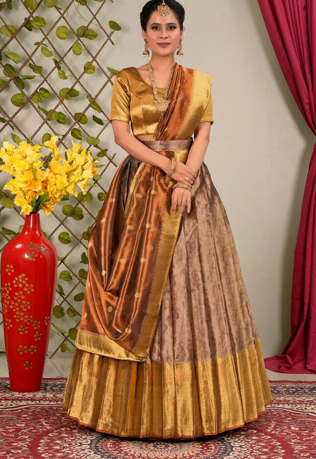 Woman in a traditional gold and brown lehenga choli with dupatta