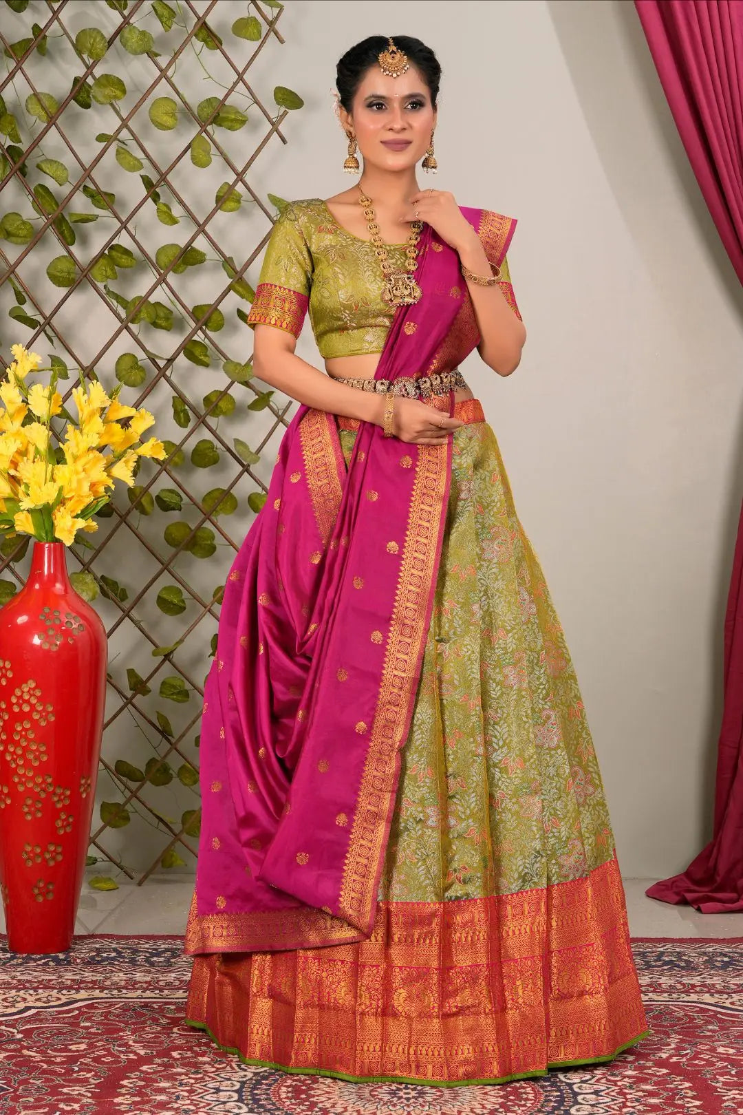 Woman wearing a traditional green and pink lehenga choli with dupatta