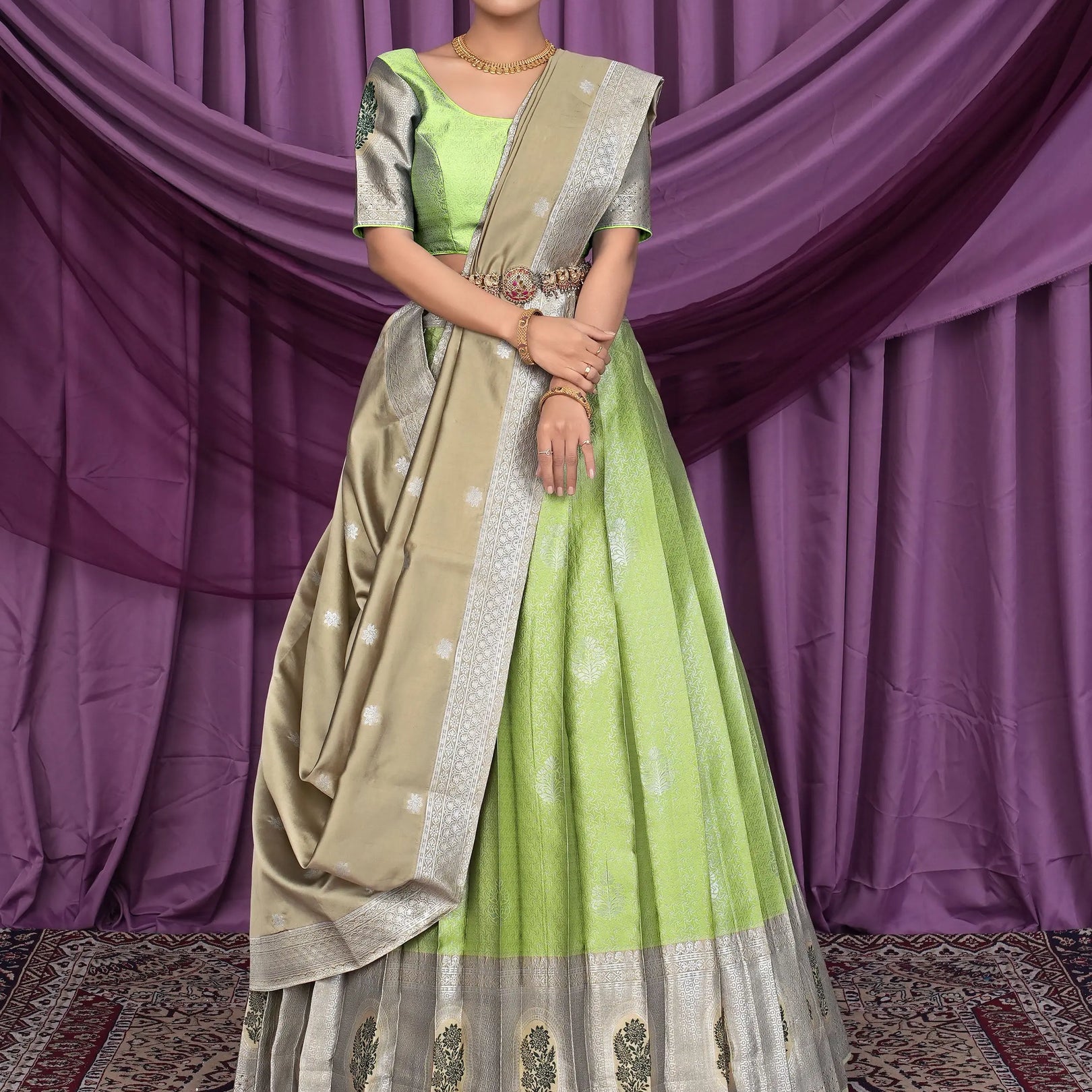 Woman wearing a green and beige lehenga choli