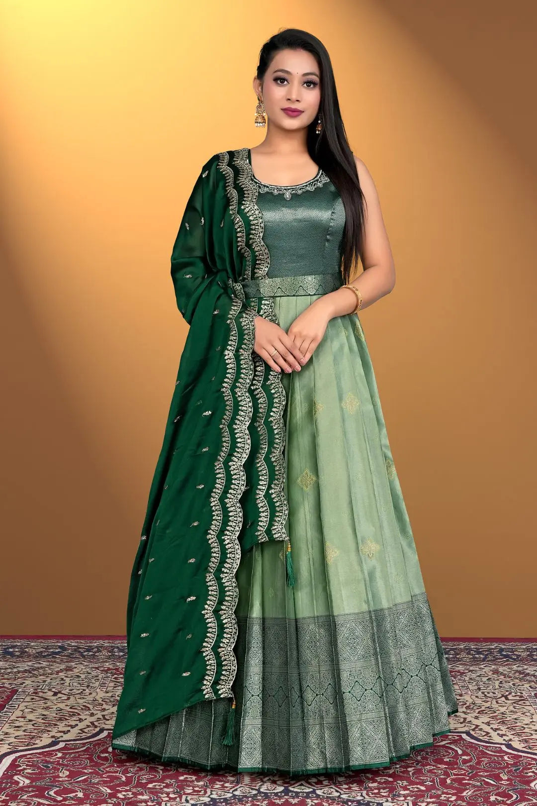 Woman wearing a green traditional outfit with a matching dupatta