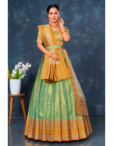 Woman wearing a traditional green and yellow lehenga choli with dupatta