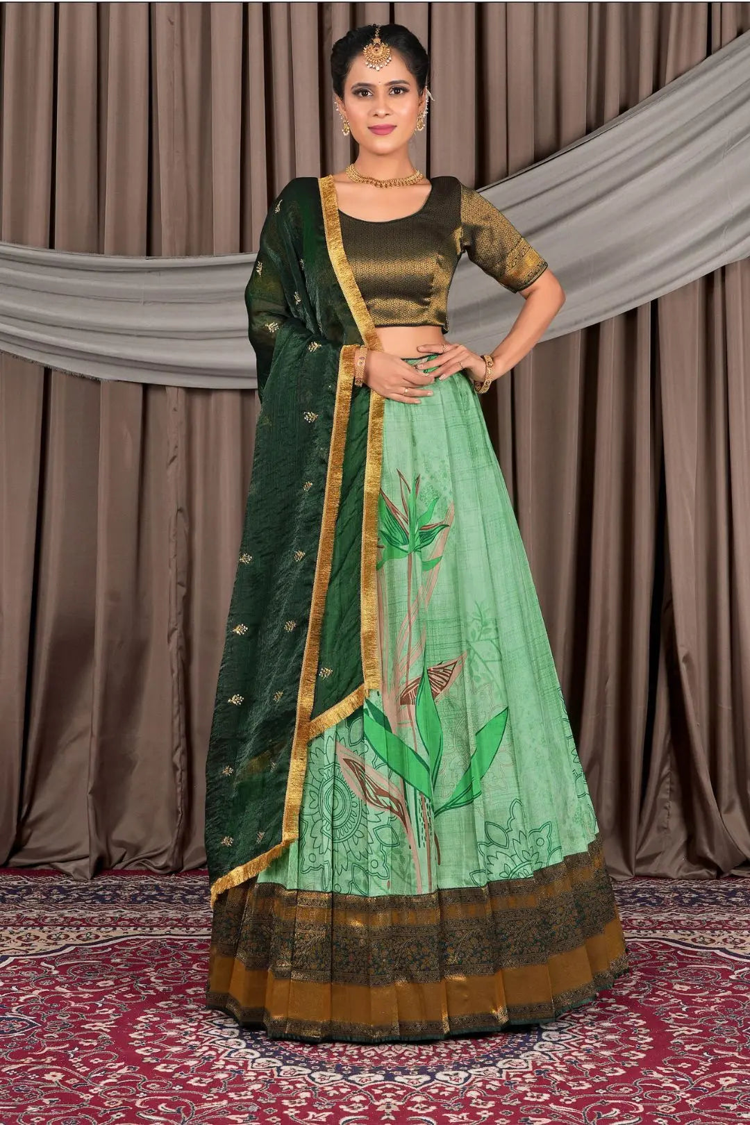 Woman wearing a green traditional lehenga choli with dupatta