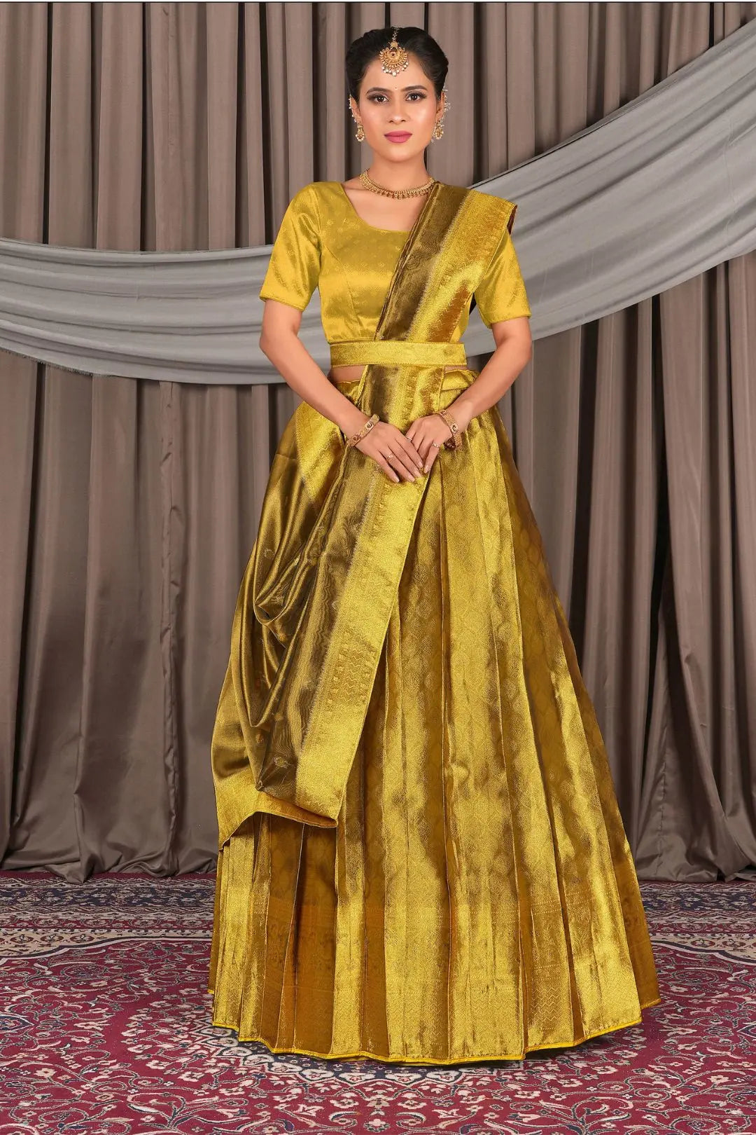 Woman wearing a yellow traditional outfit with a lehenga choli with dupatta