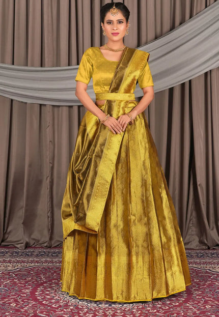 Woman wearing a yellow traditional outfit with a lehenga choli with dupatta