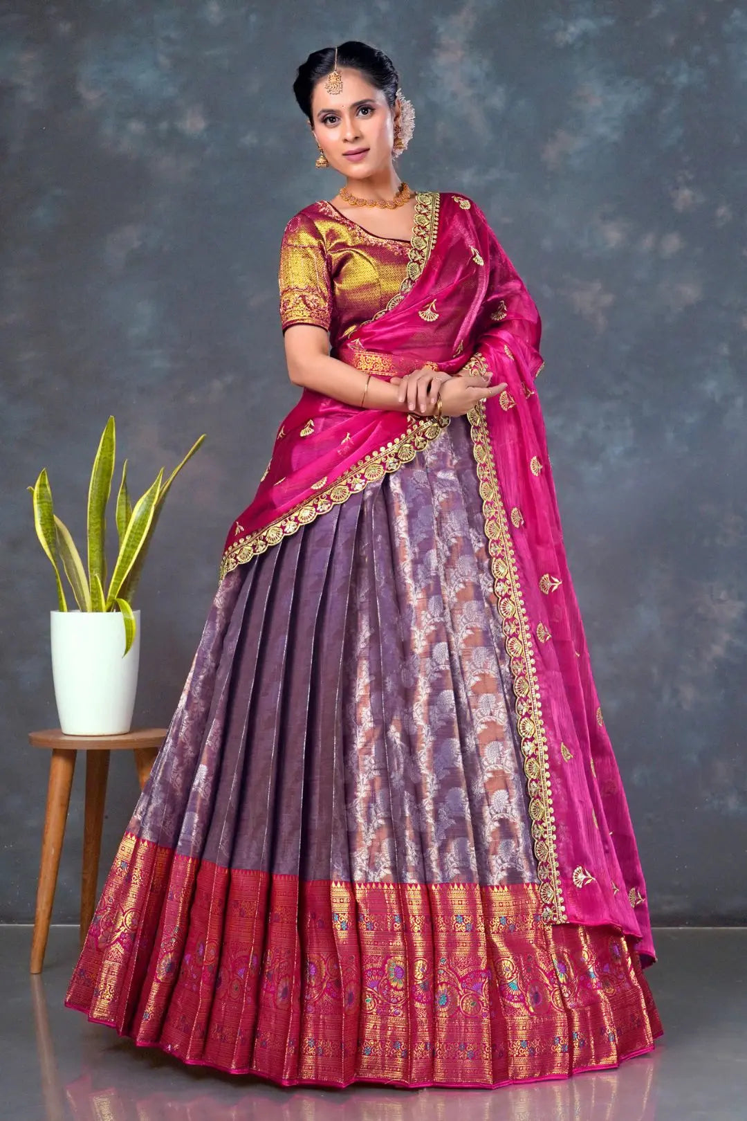 Woman wearing a traditional lehenga choli with a pink and purple design