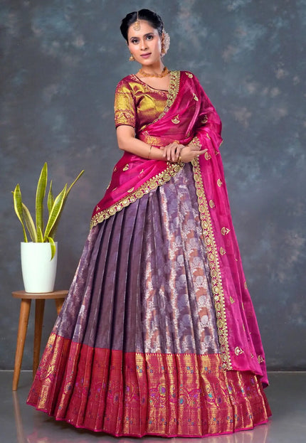 Woman wearing a traditional lehenga choli with a pink and purple design