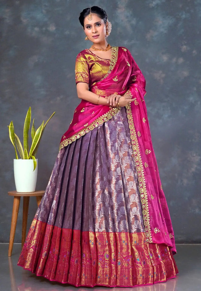 Woman wearing a traditional lehenga choli with a pink and purple design