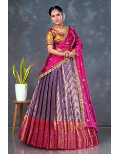 Woman wearing a traditional lehenga choli with a pink and purple design