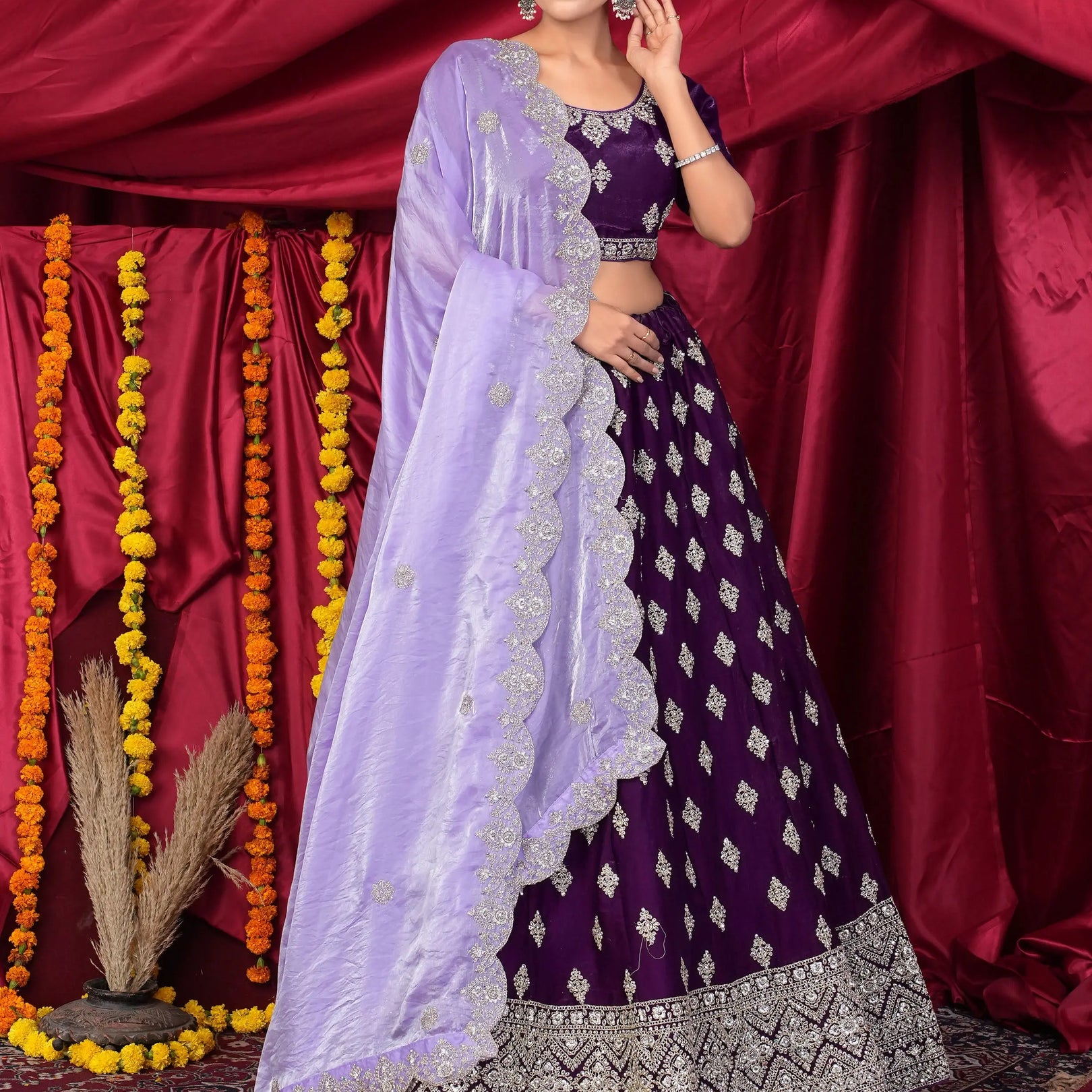 Woman in a traditional outfit with a purple lehenga choli