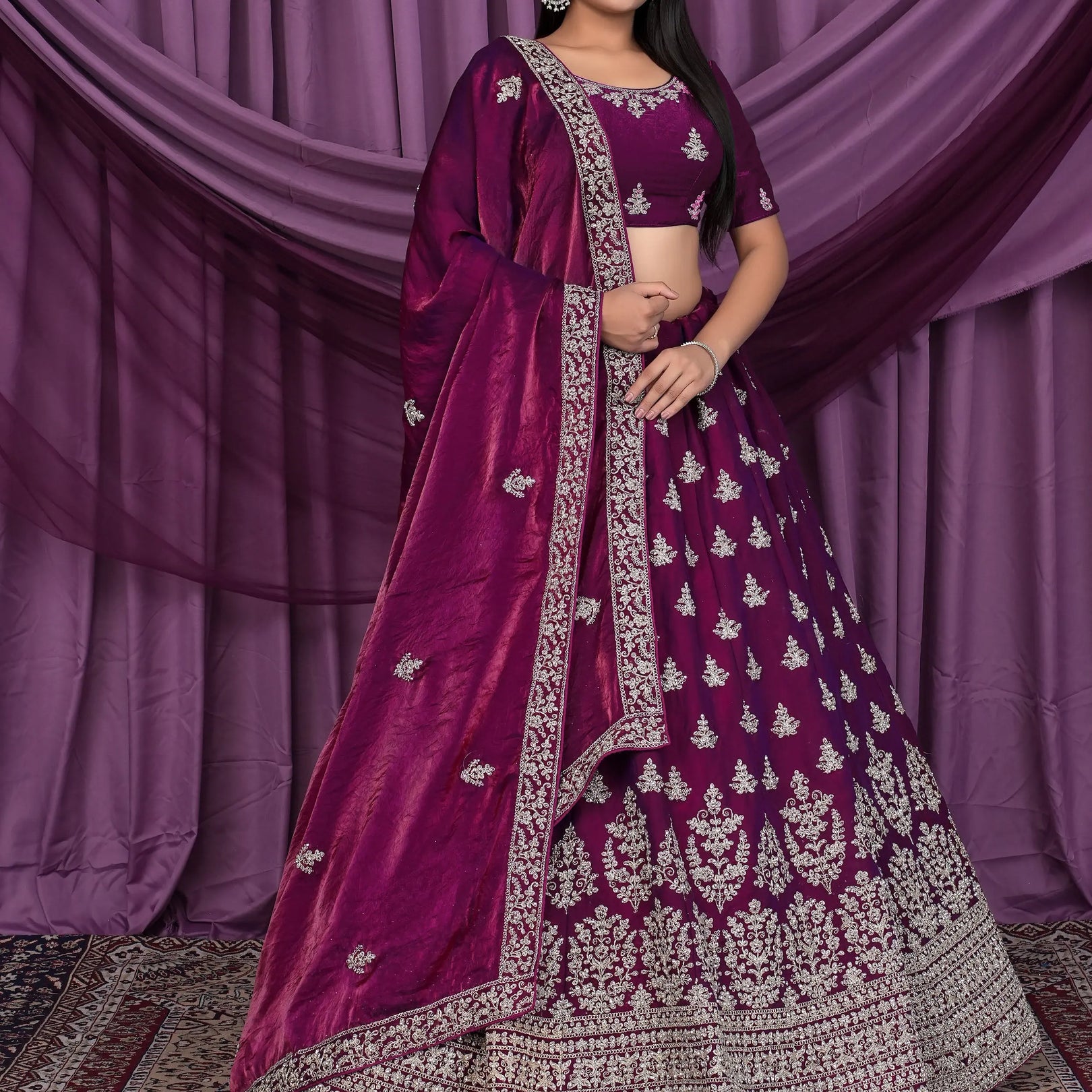 Woman wearing a traditional purple and silver embroidered outfit