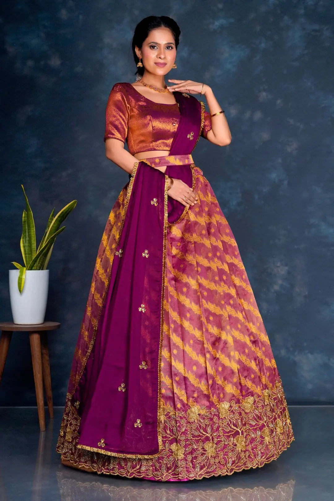 Woman wearing a traditional purple lehenga choli with dupatta