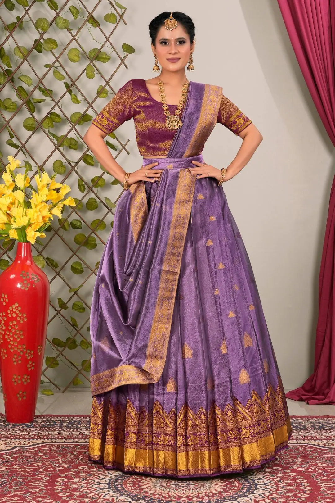 Woman wearing a traditional purple lehenga choli with dupatta
