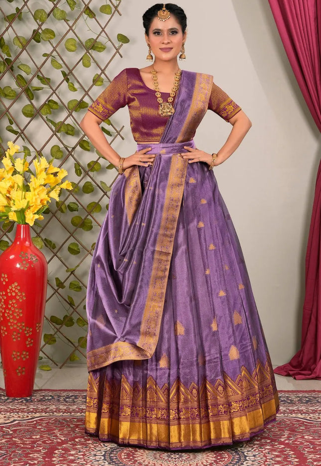 Woman wearing a traditional purple lehenga choli with dupatta
