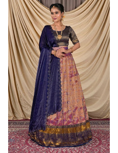 Woman wearing a traditional outfit with a blue dupatta and patterned skirt