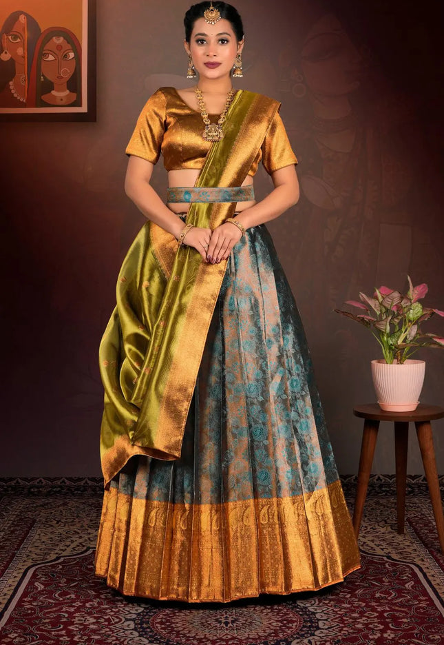 Woman in a traditional gold and blue lehenga choli with dupatta
