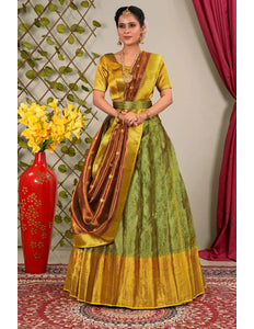 Woman in a green and gold traditional lehenga choli with dupatta