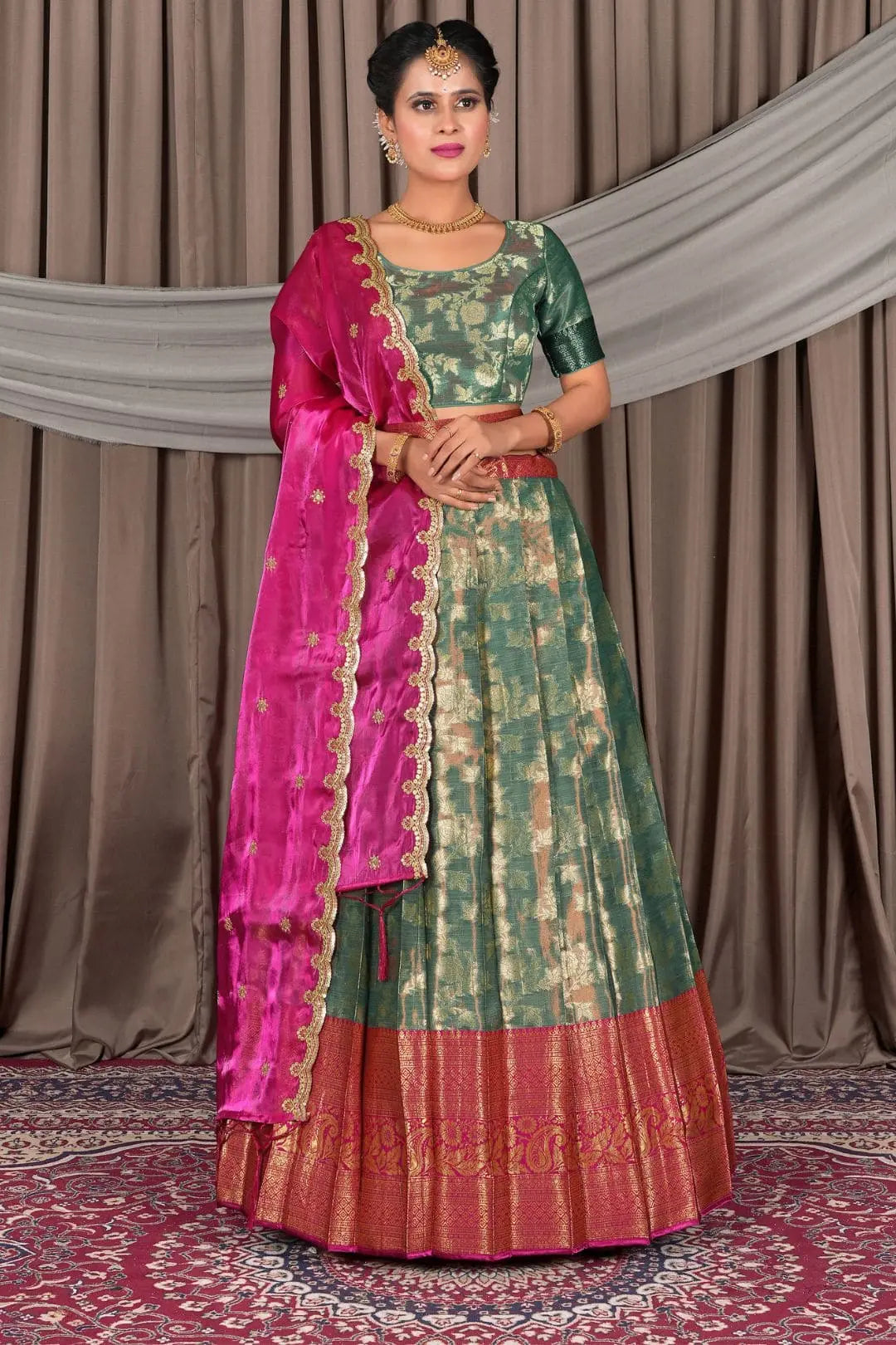 Woman wearing a traditional green lehenga with a matching blouse