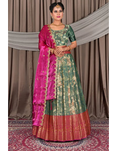 Woman wearing a traditional green lehenga with a matching blouse