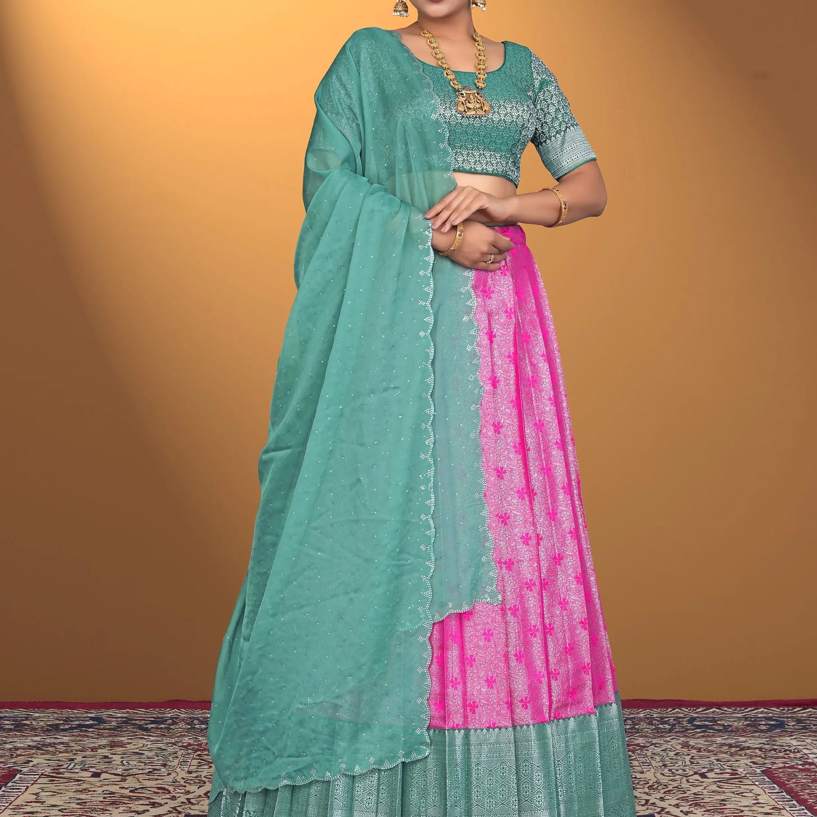 Woman wearing a green and pink lehenga choli