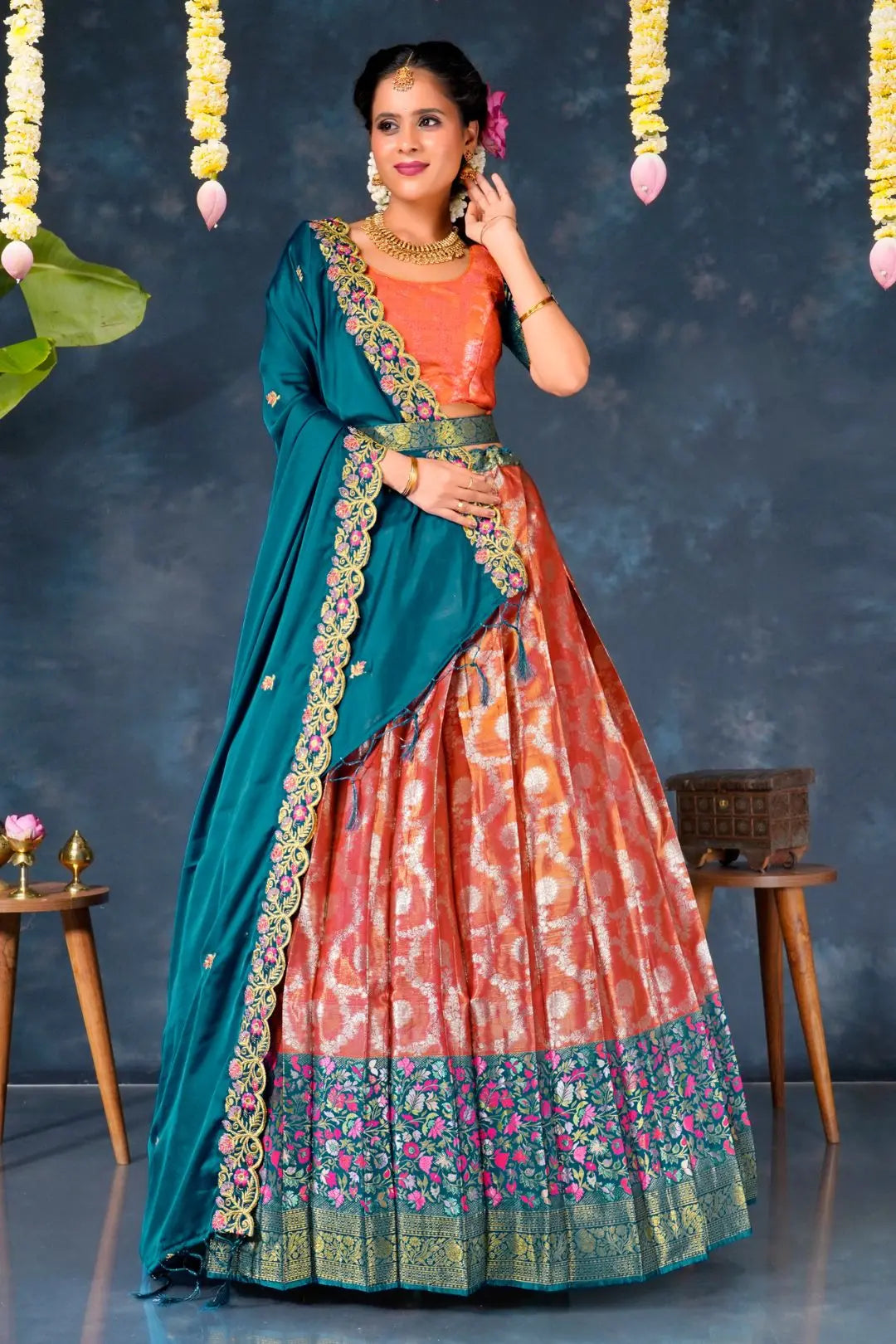 Woman wearing a pink and blue traditional lehenga choli with dupatta