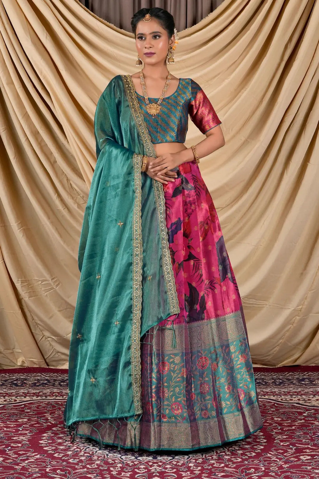 Woman wearing a traditional lehenga choli with a green and pink patterned design