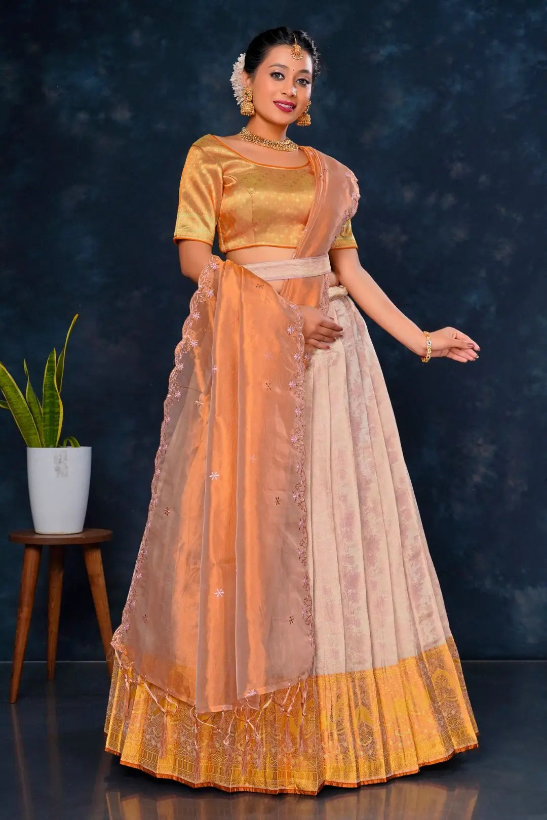 Woman in traditional outfit with orange and beige colors