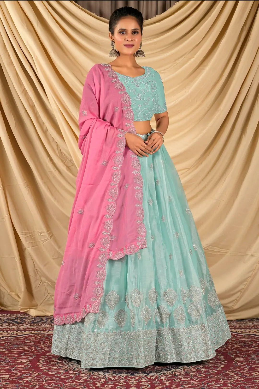 Woman wearing a light blue and pink traditional lehenga choli with dupatta