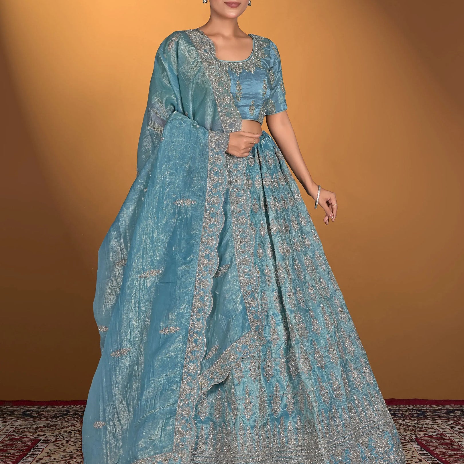 Woman wearing a blue traditional outfit with a matching dupatta