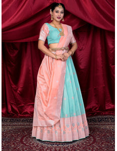 Woman wearing a traditional outfit with a pink and light blue lehenga choli