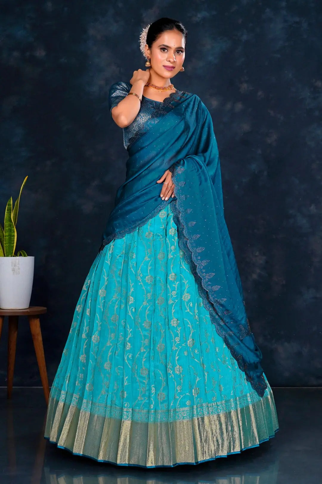 Woman wearing a blue lehenga choli with contrast dupatta