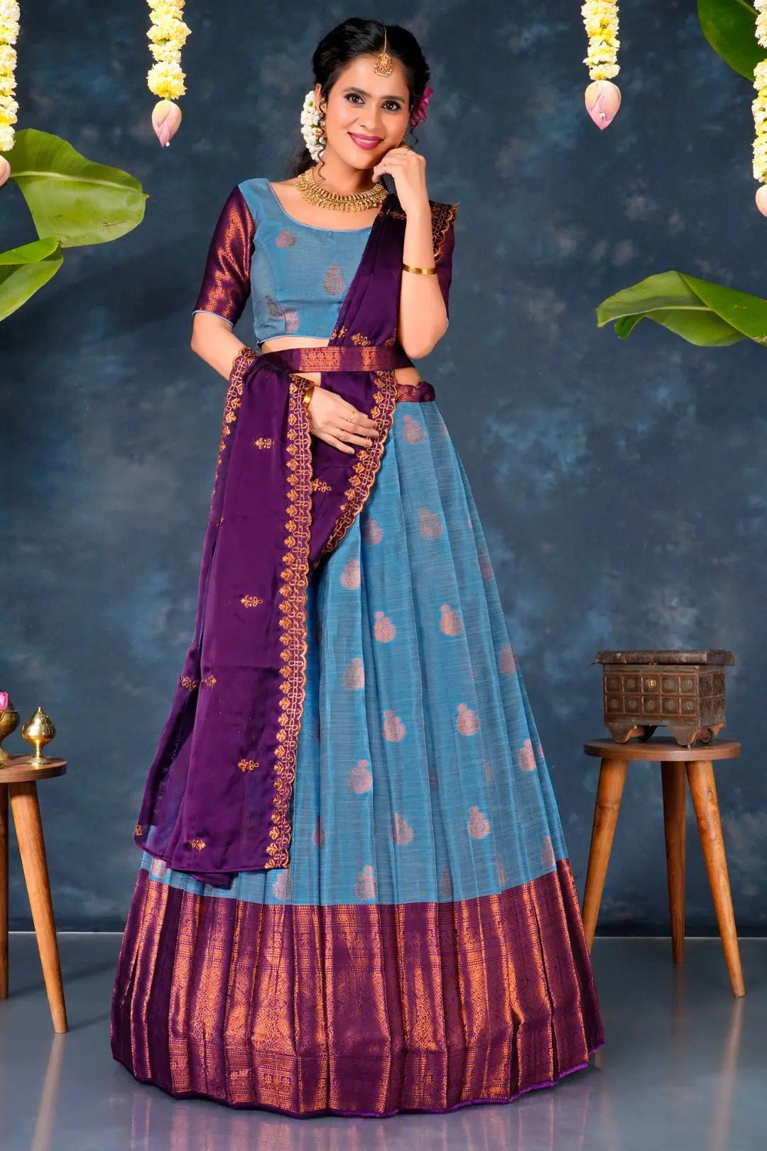 Woman in a traditional sky blue and purple lehenga choli with dupatta