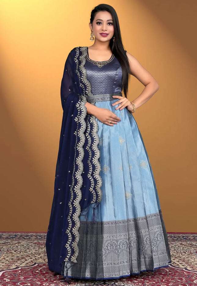 Woman wearing a sky blue traditional outfit with a blue dupatta