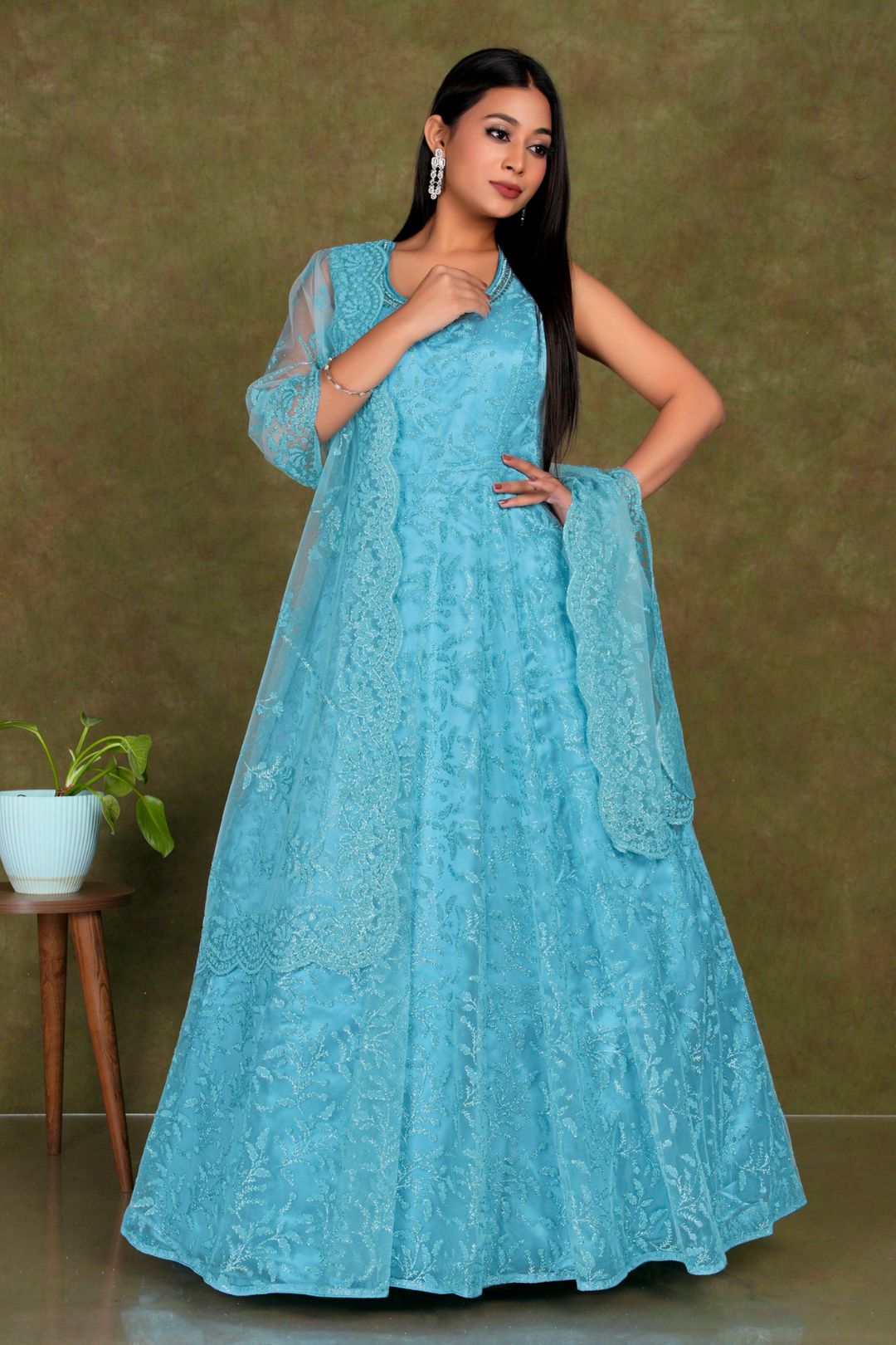 Woman wearing a embroidered Sky Blue Colour Party Wear Net Gown For Women