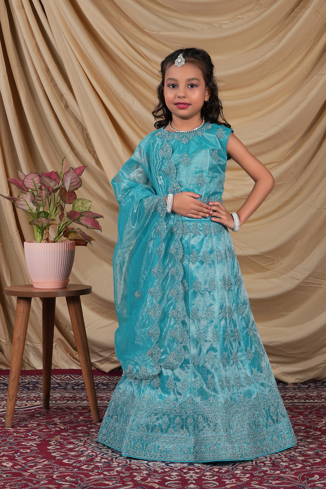 Young girl in a turquoise embroidered ready-made lehenga for girls