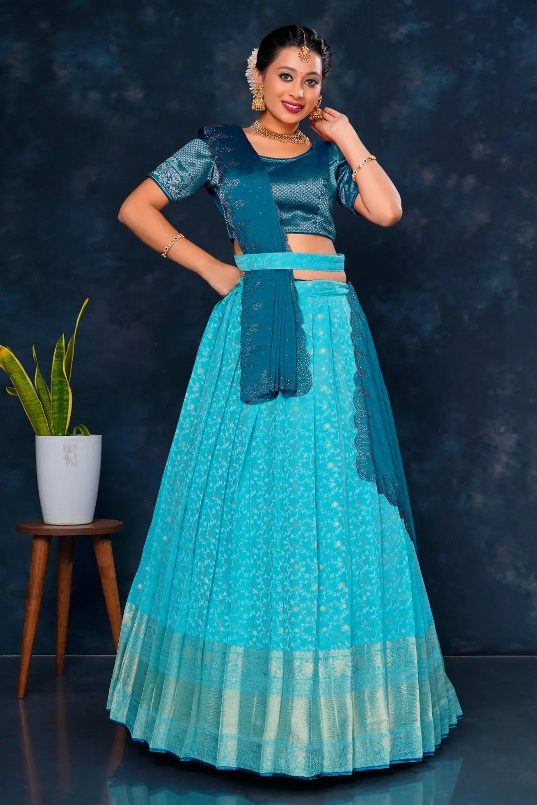 Woman in a teal traditional lehenga choli with dupatta