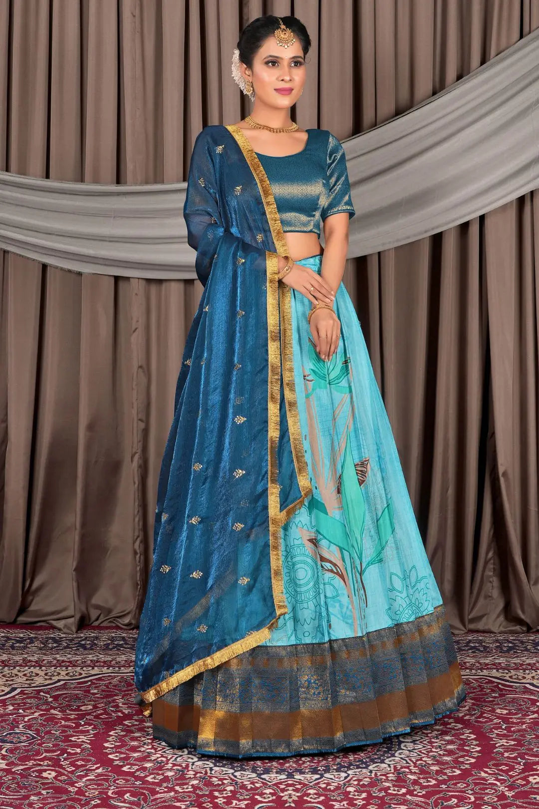 Woman wearing a traditional blue outfit with gold accents